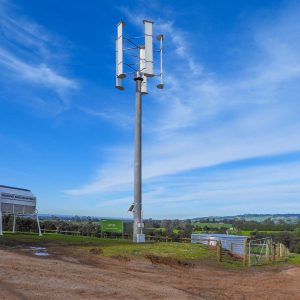 Vertical Axis Wind Turbine (VAWT) mounted on a 12-meter pole to optimize wind flow across the hills.